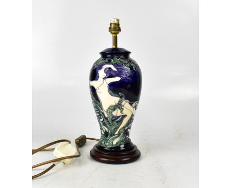 In the style of Moorcroft, a ceramic baluster lamp, cobalt blue ground with tubelined decoration of naked female, height 28cm