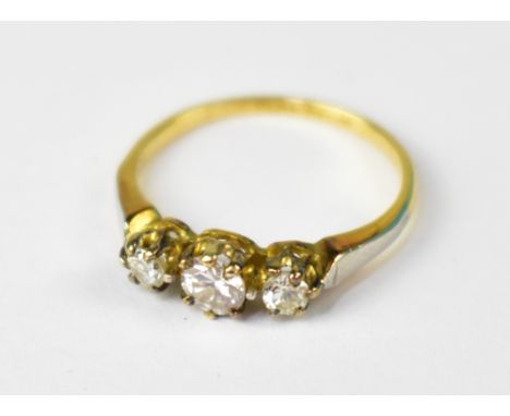 A yellow gold and platinum ring set with central diamond, approx 0.2ct, flanked by two smaller diamonds, approx 0.07ct each, 