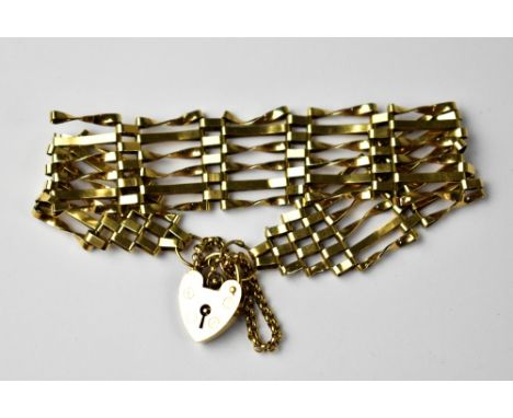 A 9ct gold six bar gate bracelet united by a 9ct gold heart-shaped padlock clasp, length approx 18cm, approx 13.4g.