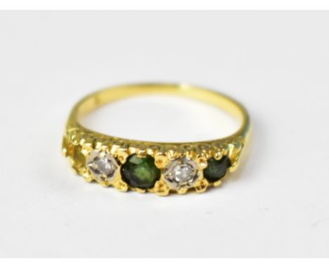 A yellow gold ring set with central green stone flanked by two tiny illusion set diamonds and smaller green stones, size N, a