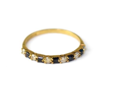 A 9ct gold blue and white stone half eternity ring, on a 9ct yellow gold shank, size O, approx 1.2g.