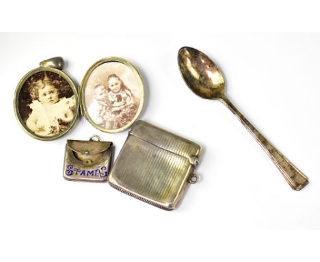 A small silver stamp case with the word 'Stamps' in blue enamel, a small hallmarked silver vesta case, a plated spoon and a w