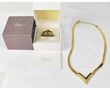 CHRISTIAN DIOR; a boxed metal dress ring with distinctive check Dior design, with certificate and a gilt necklace with wishbo