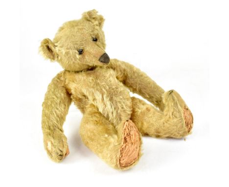 ATTRIBUTED TO STEIFF; an early pre-WWI golden mohair teddy bear with small rounded ears, black boot button eyes, horizontal s