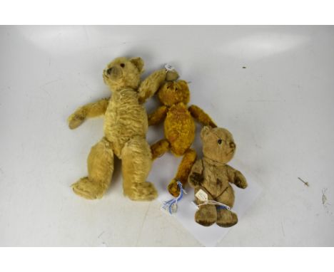 Three early 20th century teddy bears, a Stick bear, a straw-filled growler bear (af) and a small c1930s-1950s bear with straw