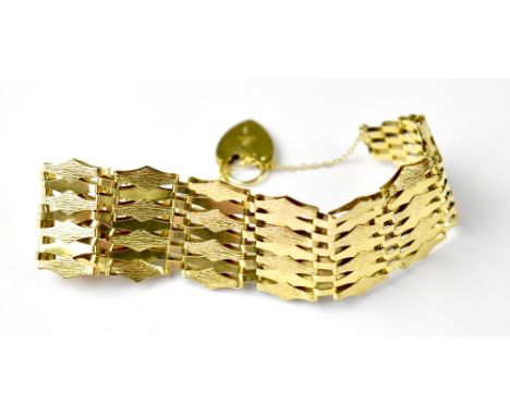 A 9ct gold fancy gate bracelet with seven-lozenge shaped bars, textured finish and 9ct gold heart-shaped padlock clasp, lengt