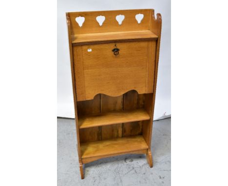 An early 20th century oak students' bureau, the three-quarter galleried top with pierced decoration above fall front, fitted 