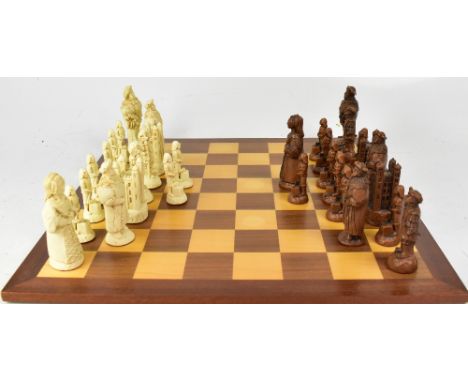 A wooden chessboard, 50 x 50cm and a brown and white resin chess set in the Old Kings of England style, height of king 10.5cm