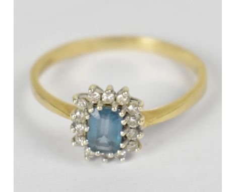 A 9ct yellow gold ladies' dress ring with emerald cut aquamarine stone and small diamond surround, size T, approx 2.1g.