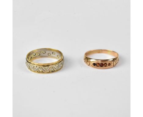 Two 9ct yellow gold dress rings, comprising an Edwardian-style example set with five small rubies and a yellow and white gold