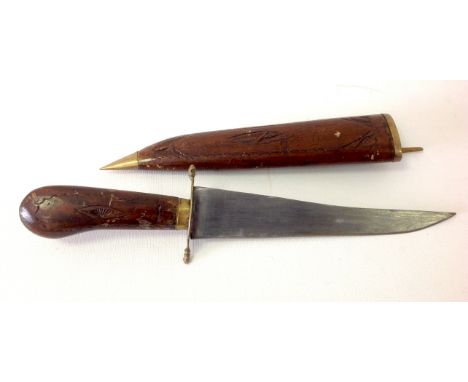 A carved handled dagger in a carved wooden sheath with brass clasp. 34cm total. Blade 20cm