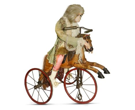 A Victorian fairground figure of a monkeythe papier mache figure with a painted face and glass eyes, dressed in a silk jacket