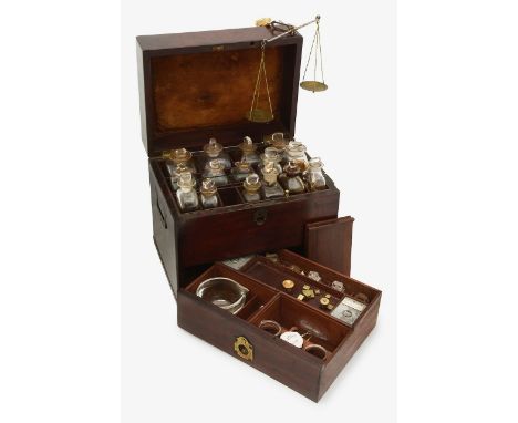 A Victorian mahogany apothecary boxthe lid opening to reveal a divided interior containing fifteen square glass bottles of va