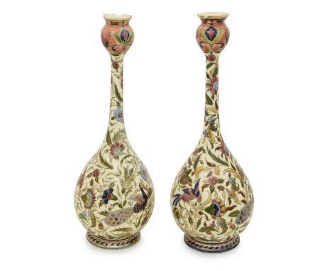 A pair of Zsolnay Pecs pottery vases 19th century, Hungarian, in the Islamic taste, of bottle form, densely decorated with pe
