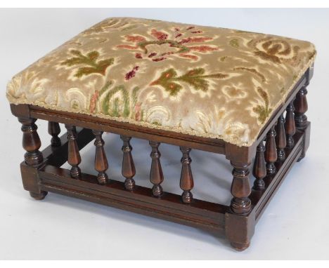 An Edwardian mahogany stool, with padded seat and turned spindle supports.