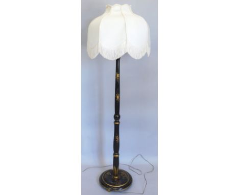 A black japanned standard lamp, with modern shade, 176cm high overall.