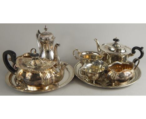 Two silver plated tea sets, each with associated tray and a silver plated coffee pot.