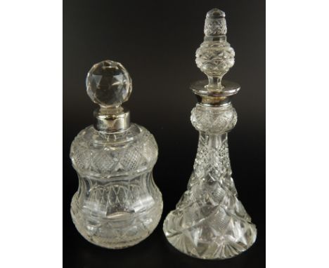 Two similar early 20thC cut glass scent bottles, each with a stopper and a silver collar.