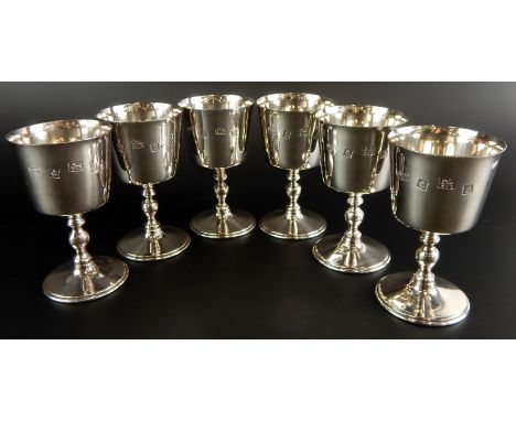A set of six Elizabeth II silver goblets, each with a tapering bowl, turned column and domed foot, Birmingham 1974, 37¾oz.