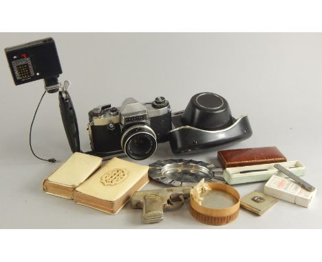 A collection of items, to include a Praktica camera, with accessories, two prayer books, a tape measure engraved Herman Marsh