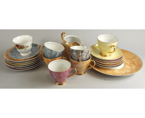 A 20thC Polish part service, in marbled effect in various colours, to include serving plate 24cm dia., cups, saucers, jug, et