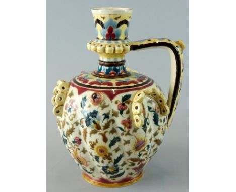 A late 19thC Zsolnay Pecs ceramic ewer, decorated with Islamic style flowers, leaves etc., in pink, red, pale blue, green etc