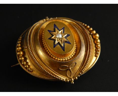 A Victorian brooch, with blue enamel decoration and central seed pearl, with memorial panel to back, bloom gold. 