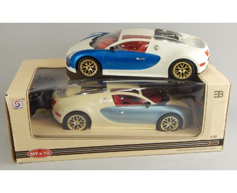 A Synergy Toys die-cast 1:10 scale model remote controlled car, 34cm wide, and another. (1 boxed)