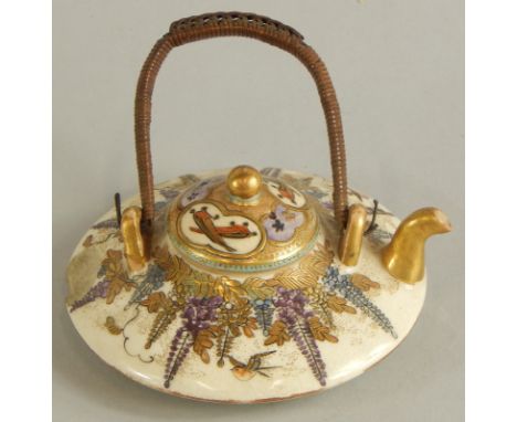 A small satsuma miniature teapot, decorated with figures, flowers etc., marked to the underside (AF)