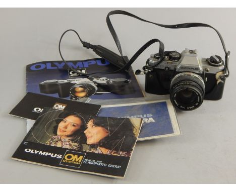 A Olympus OM10 camera, with lens and manual.