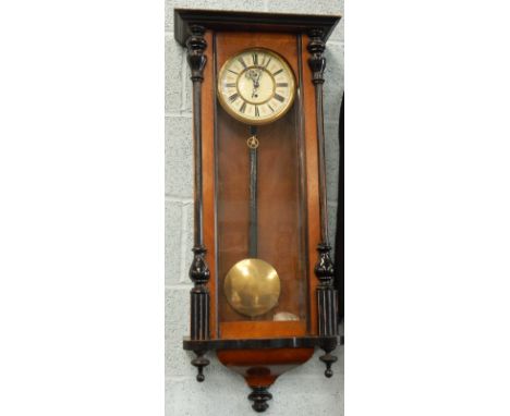 A walnut and ebonised Vienna type wall clock, with enamel type dial, 99cm high.