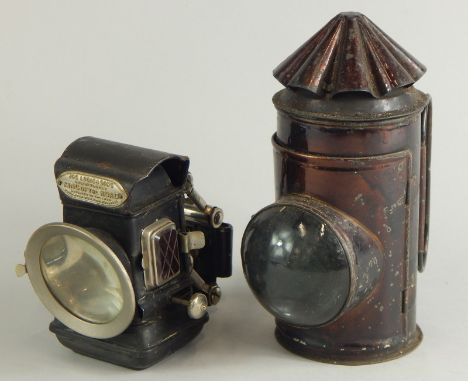 A Lucas and Sons King of The Road cycling lamp, and another bronzed metal lamp.