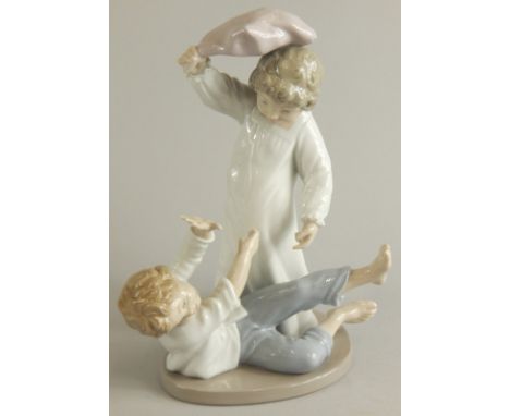A Nao porcelain figure, of two children fighting with a pillow, 24cm high