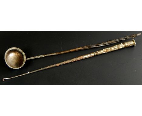 Two items of silver and white metal, a 19thC ladle with twisted whalebone handle, and a button hook embossed with figures