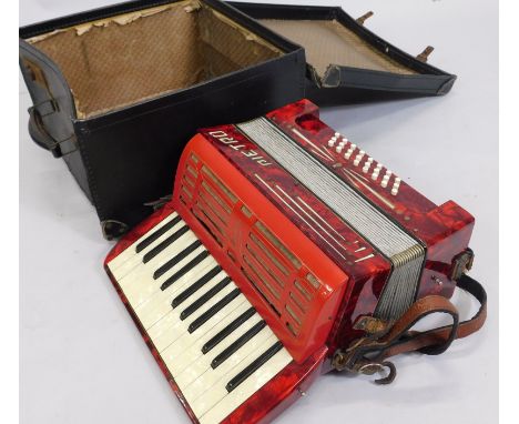 A Pietro red Bakelite type piano accordion, in canvas case.