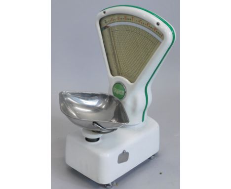 A set of Avery shop scales, in white enamel with green embellishment, 52cm high.