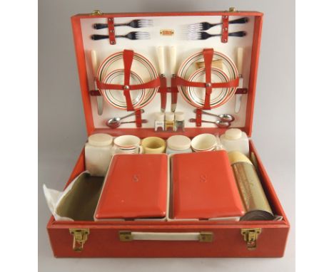 A Sirram picnic hamper, with five ceramic plates, saucers, cups, plastic containers. (AF)