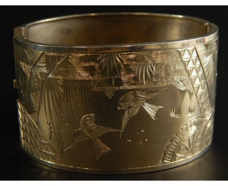A silver bangle, with engraved design of birds flying over a lake, 31.8g. 