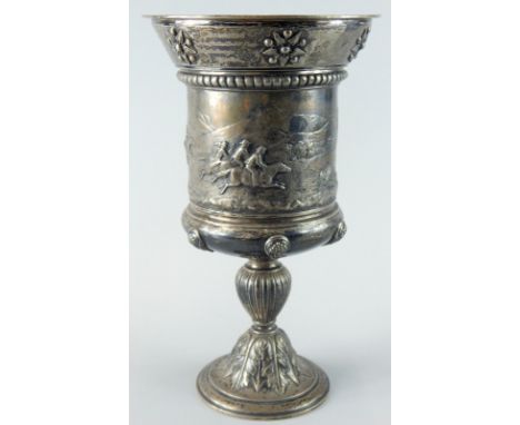 A Victorian silver horse racing trophy, the tapering border cast with patera, above a gadrooned band and a scene cast with ra