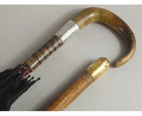 An Edwardian and gentleman's umbrella, the turned wood and horn handle with silver collar, and a strung bound or woven riding