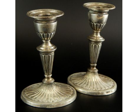 A pair of late Victorian silver candlesticks, each with a reeded oval column and tapering base, loaded, Sheffield 1896, 16.5c