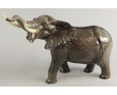 A Beswick pottery elephant, with trunk raised, printed marks beneath.