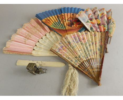 A collection of fans, to include silk example with pierced ivory sticks, a silver plated oriental rickshaw ornament, etc.