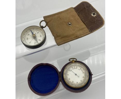 Antique pocket compass together with a gold plated pocket barometer with red protective casing. 