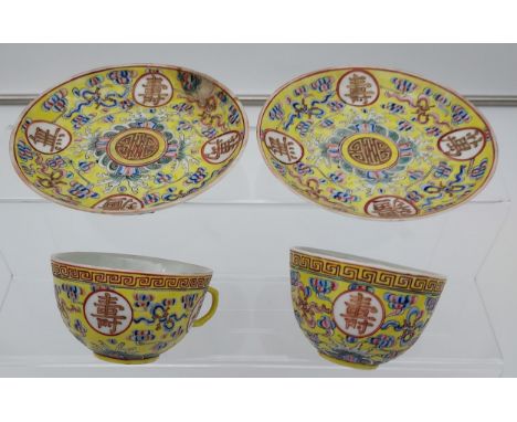 Two Chinese cups and saucers in a yellow ground, Guangxu 1875-1908 signature to the base. 