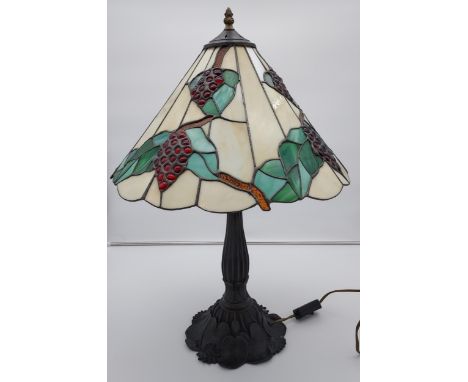 A Tiffany style table lamp. Shed designed with grapes and vines. [In a working condition] [67cm in height] 