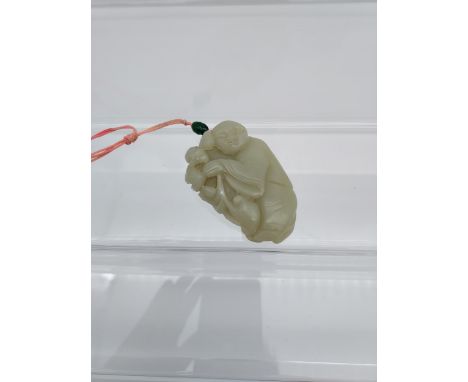 An early 20th century Chinese hand carved jade sculpture of a boy and bat. [6cm in length] 