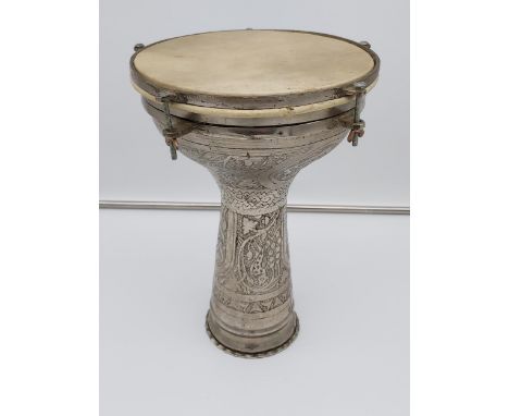 A Vintage Arabic white metal and hide drum. Body is engraved with various floral and bird designs. [34cm in height] 