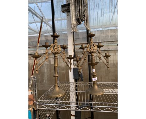 A PAIR OF VINTAGE ARTICULATED BRASS CANDLESTICKS