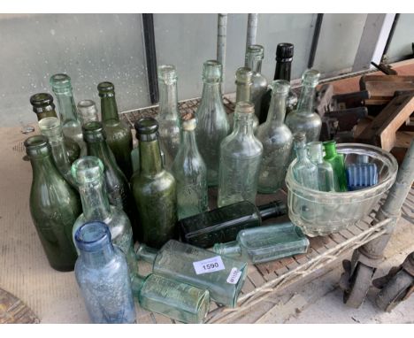 A LARGE ASSORTMENT OF VINTAGE GLASS BOTTLES SOME BEARING NAMES